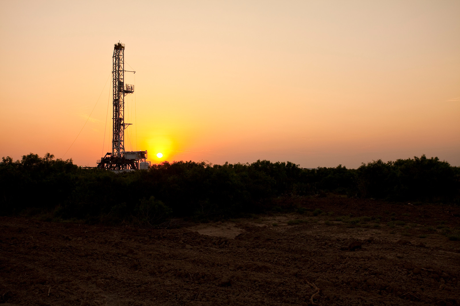 A drilling rig in the Eagle Ford Shale at sunset.