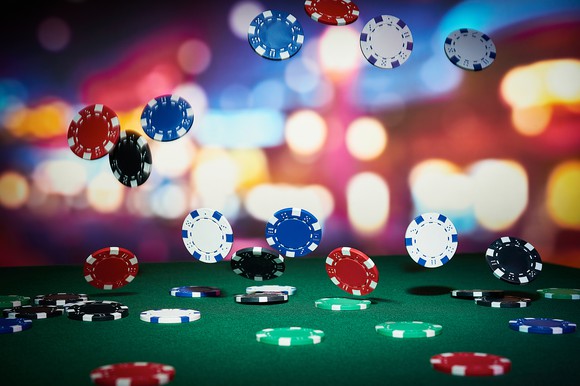 Casino chips falling on a table.