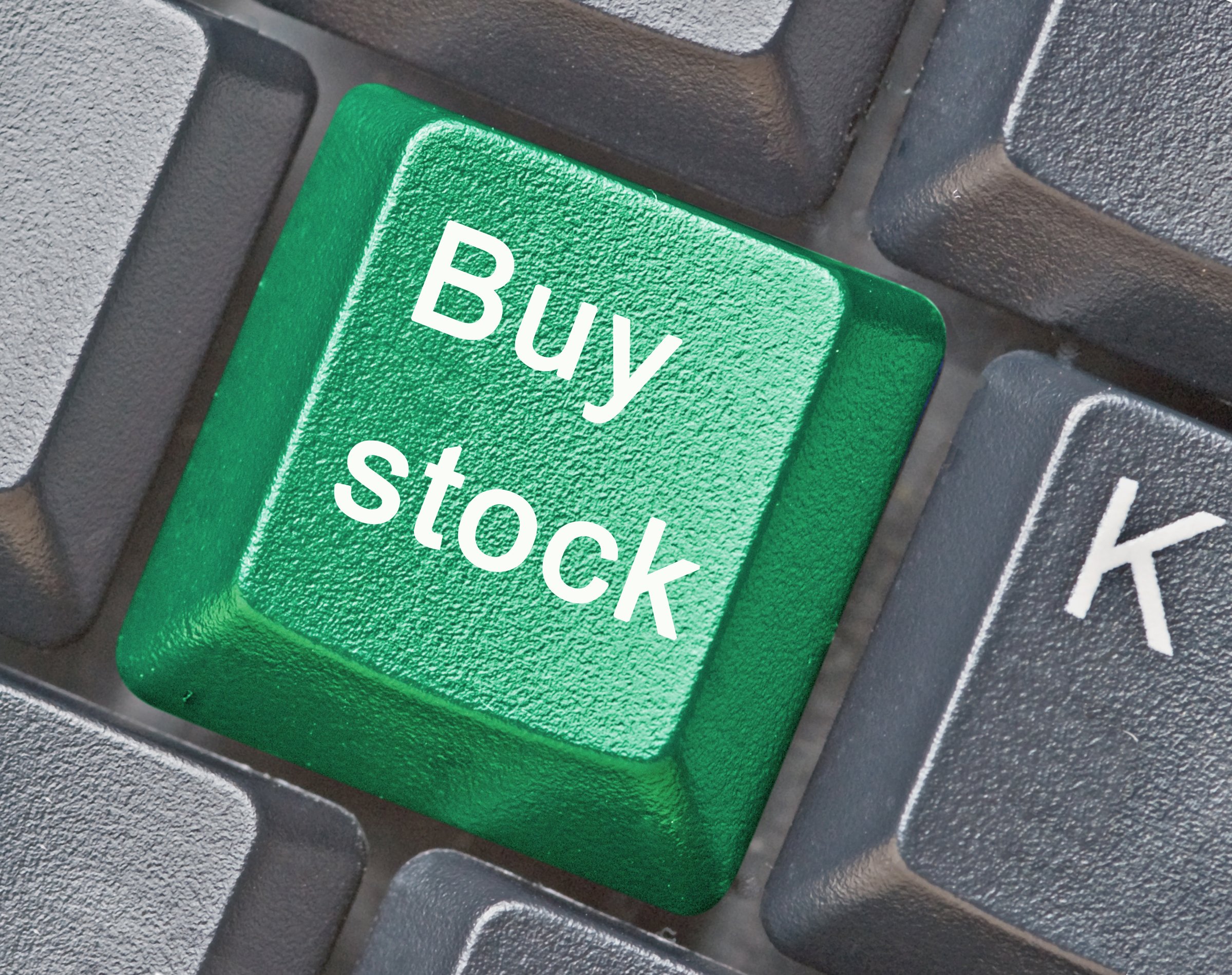 A "buy stock" button on a keyboard.
