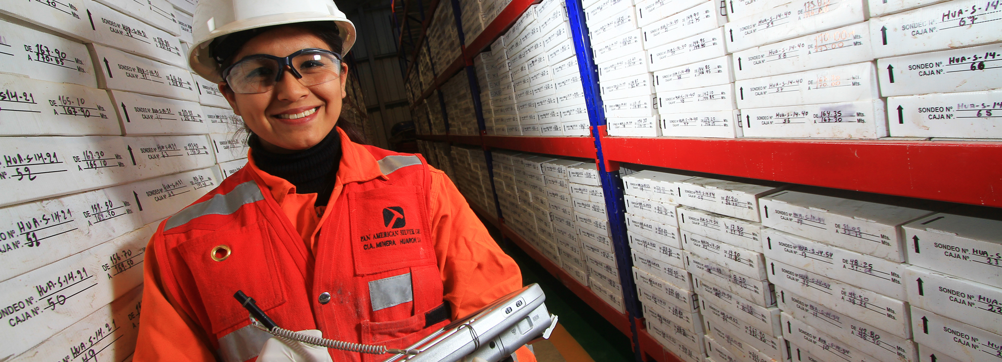 Mining worker in a warehouse filled with boxes.