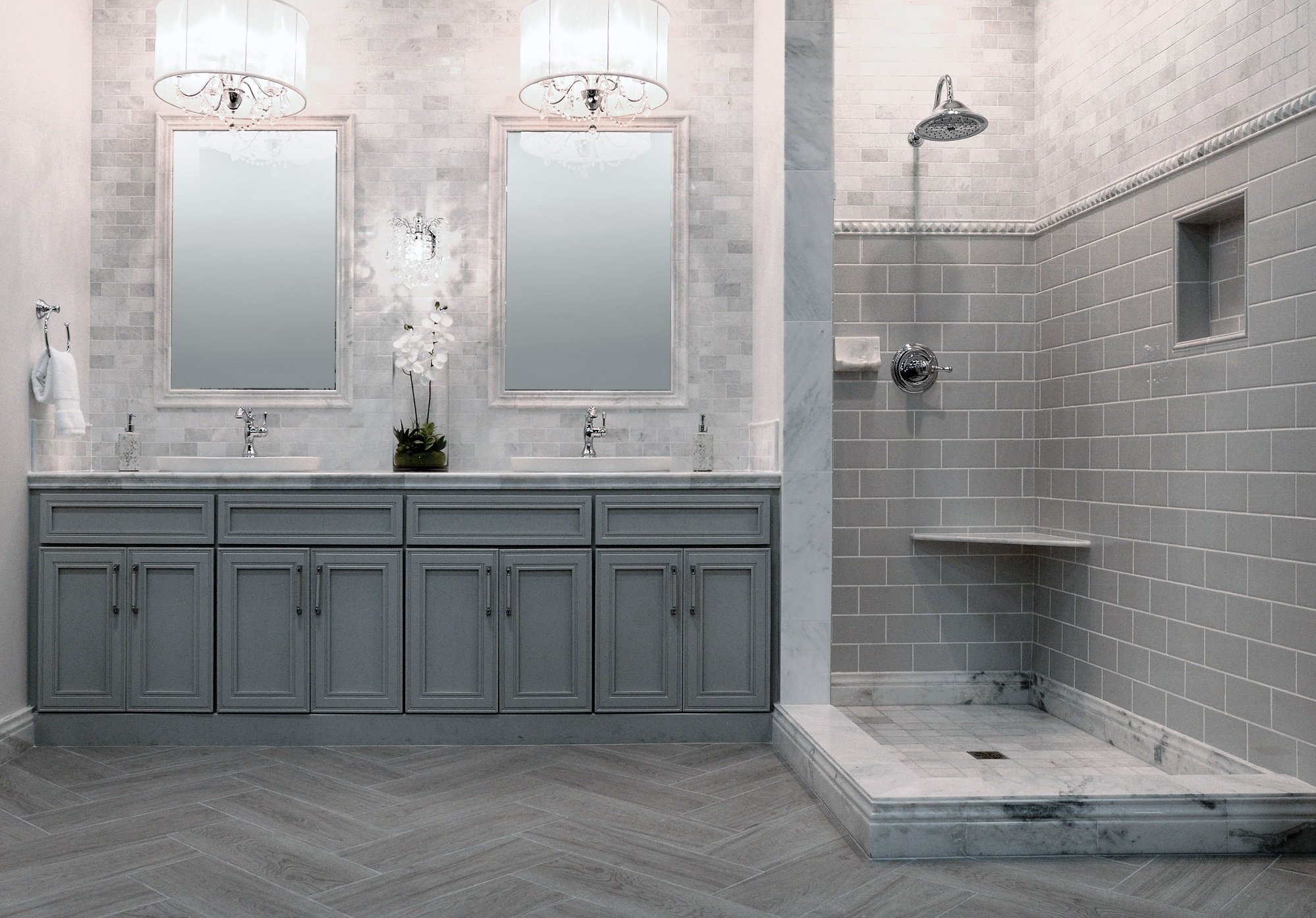 A bathroom decorated with grey colored tiles