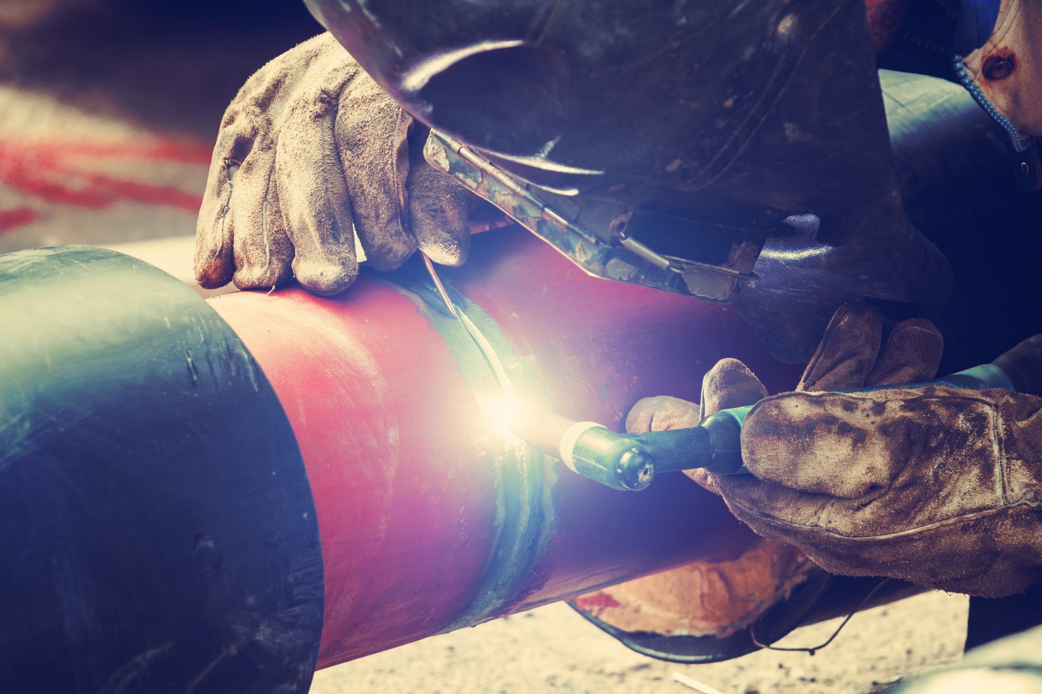 A welder working on a pipe.