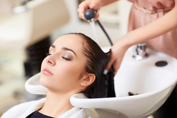 A woman getting her hair washed at a spa.