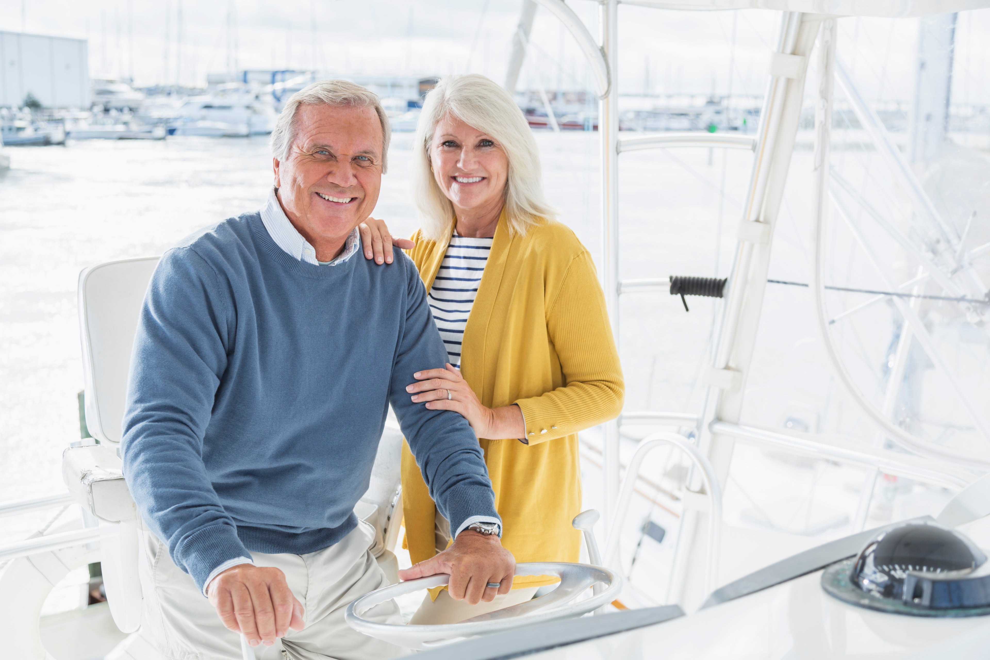 A smiling elderly couple on a boat.