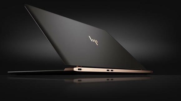 HP's Spectre laptop opening against a black background.