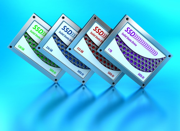 Four unbranded solid-state storage devices against a light blue backdrop.