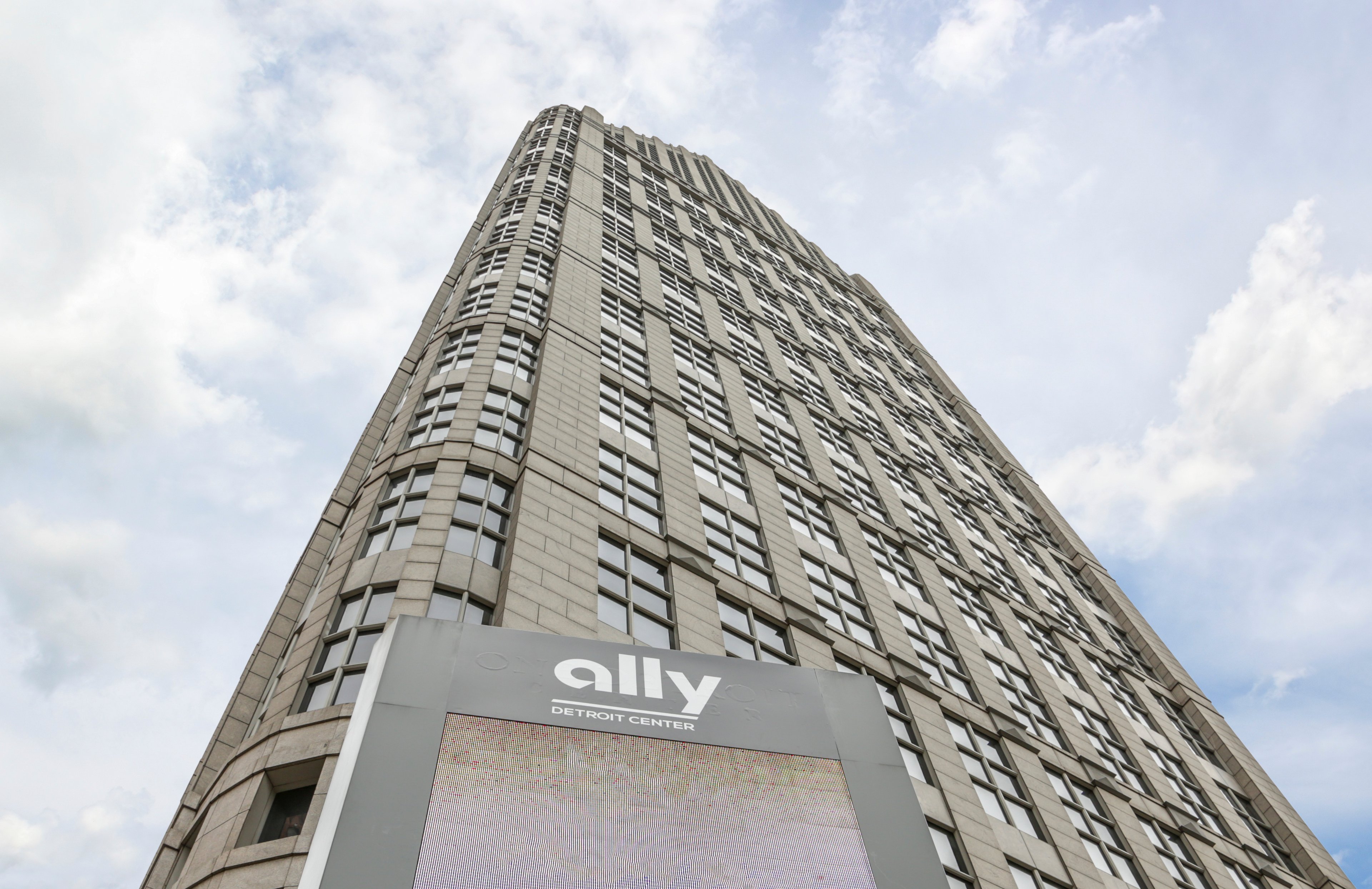 A picture of the Ally Financial Center, looking up the building with the sky in the background