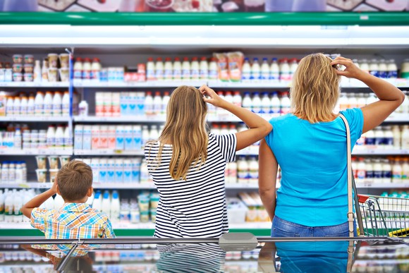 A family of shoppers scratch their heads in confusion as they look over the grocery store selections.