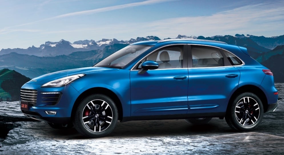A blue Zotye SR9 SUV is shown on a snowy road.