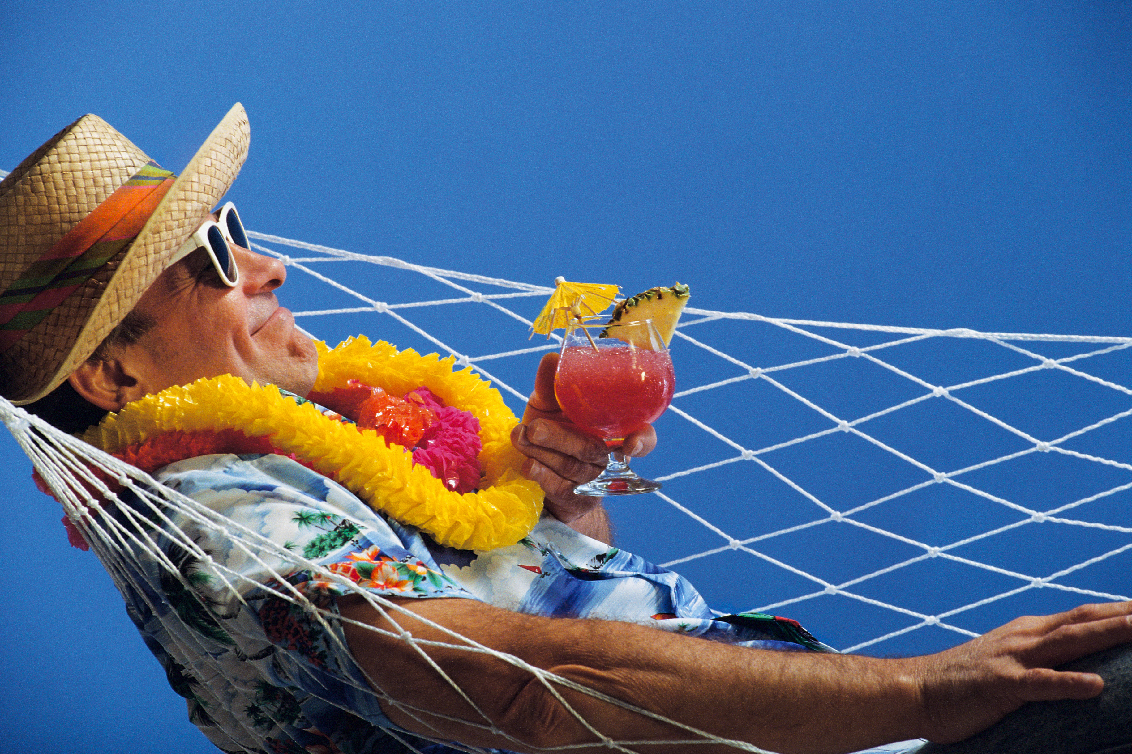 mature man in hammock with drink
