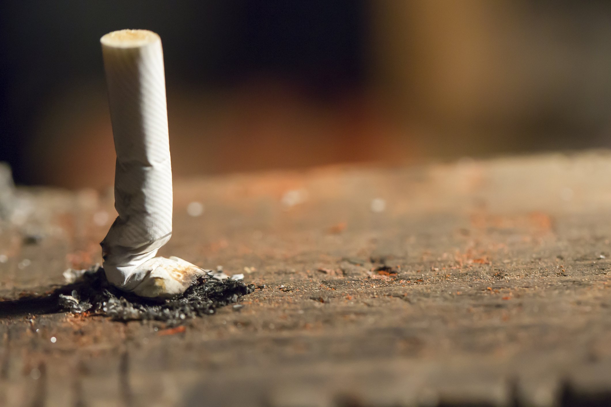A cigarette extinguished on the ground.