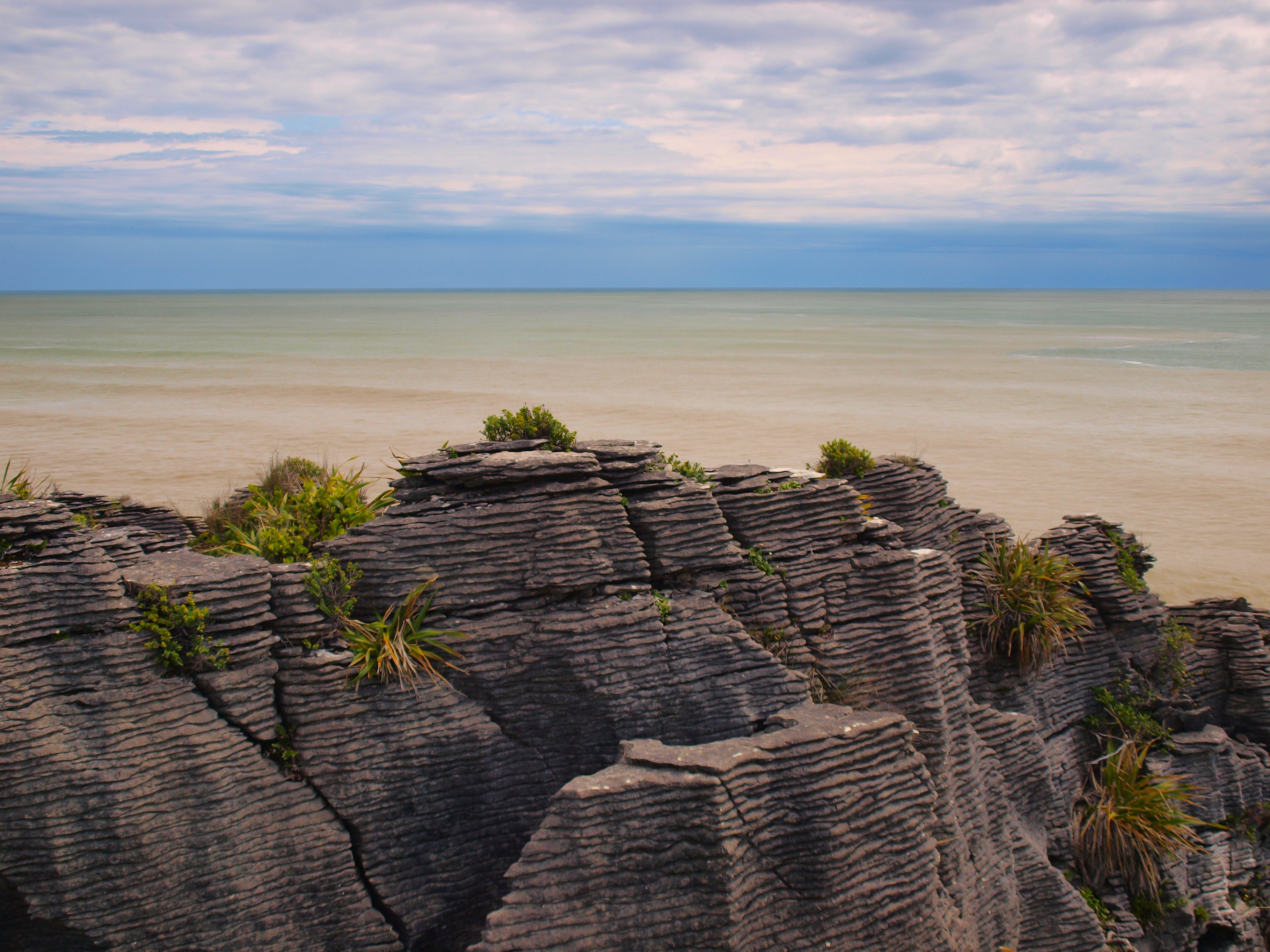 A mountain overlooks sand