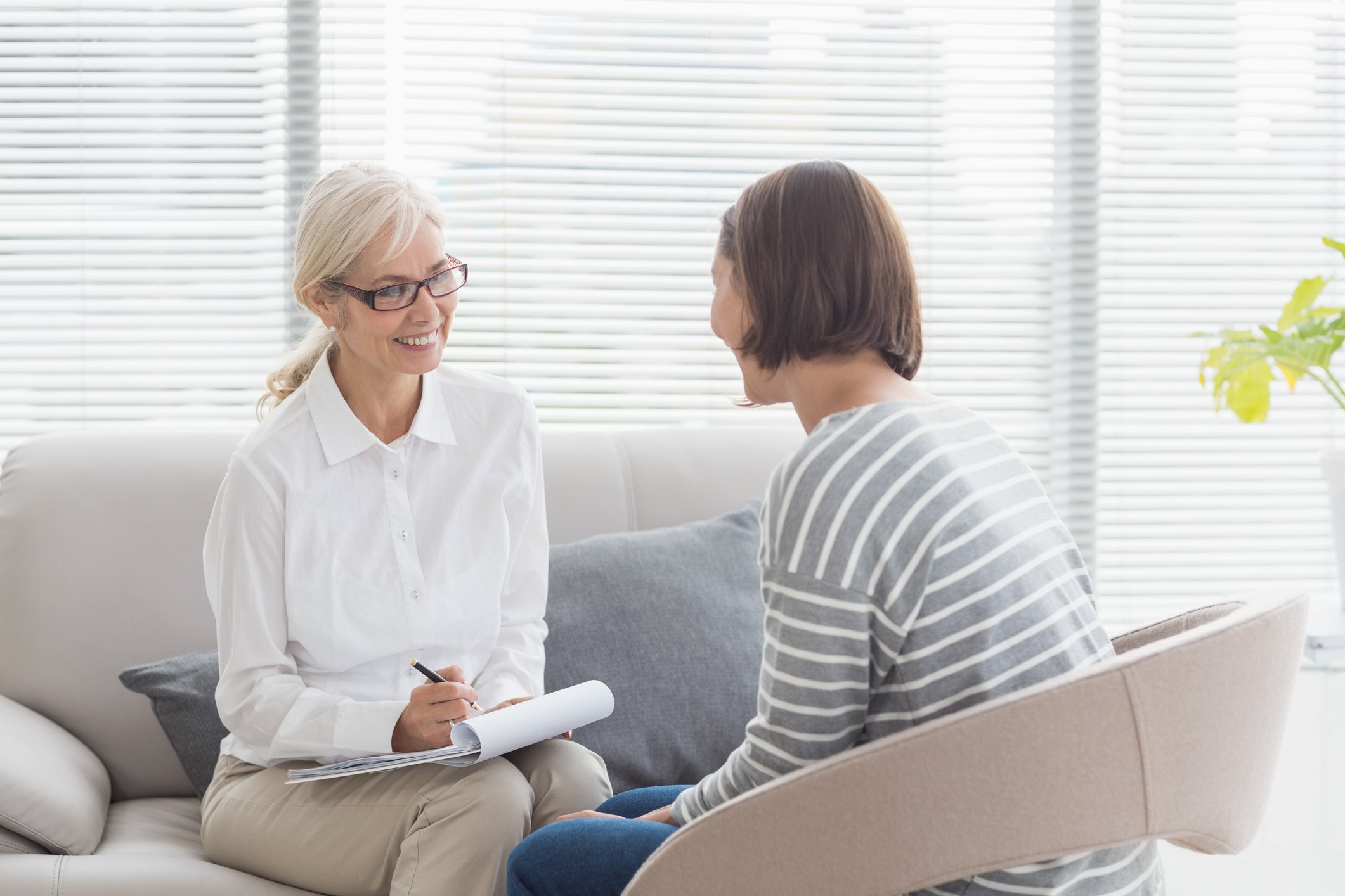A smiling therapist with a patient
