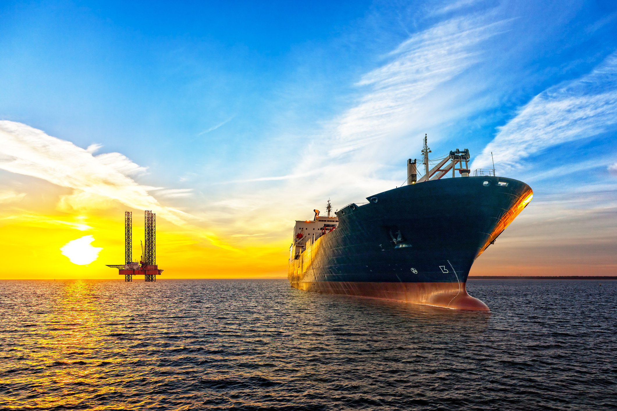A large ship in front of an oil platform