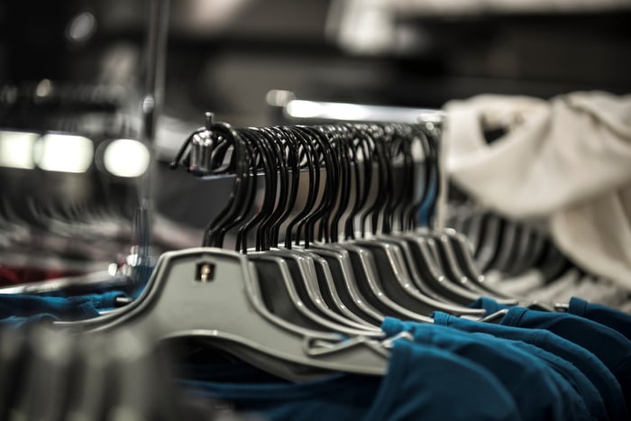 Blue and beige shirts on hangers in a clothing store
