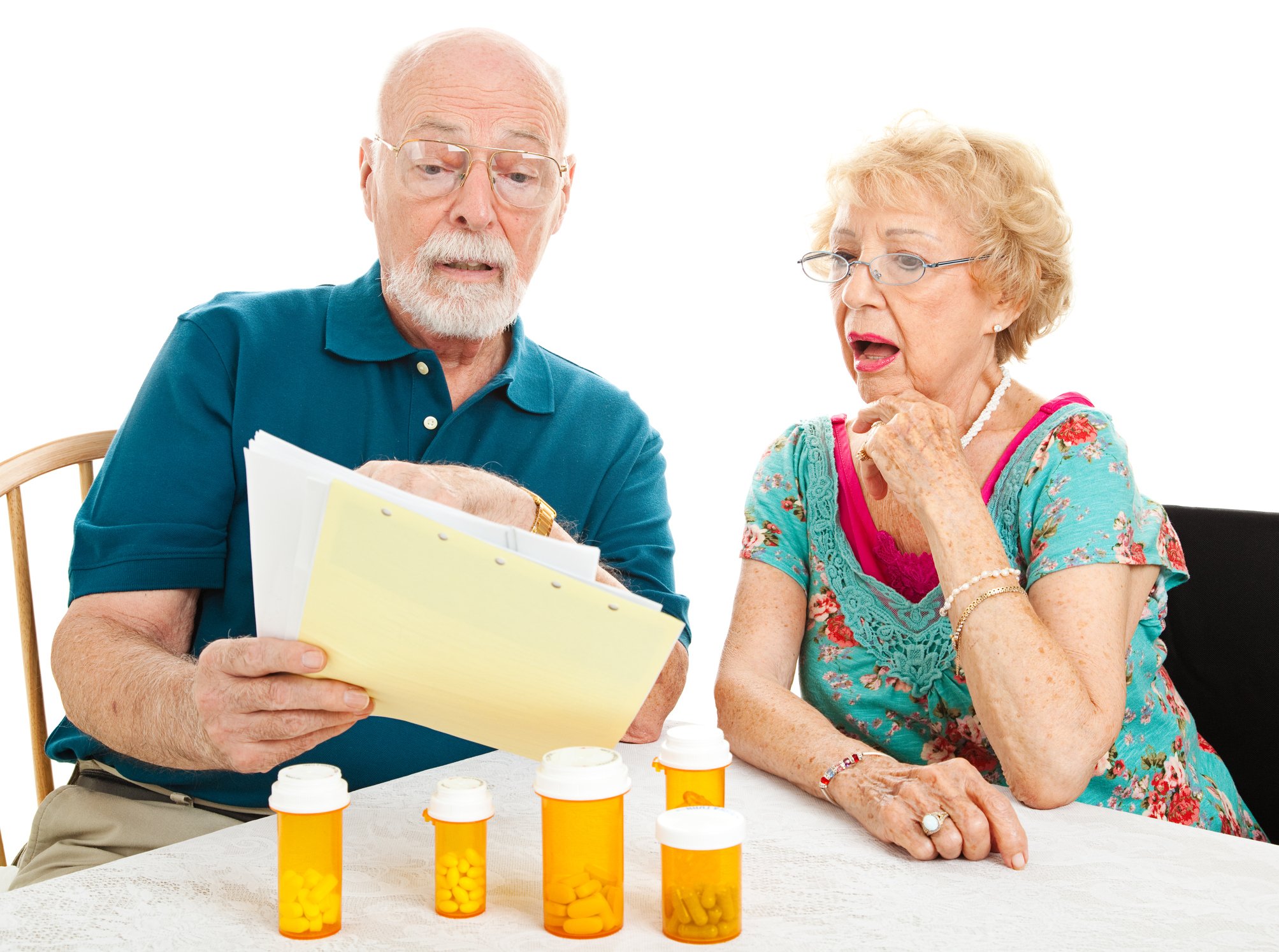 A senior couple reviews a bill for their medicine.