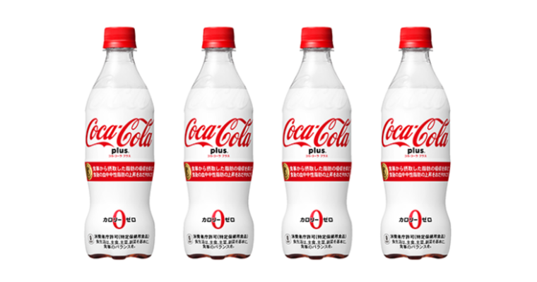 Line of four "Coca-Cola Plus" white and red Japanese beverage bottles.