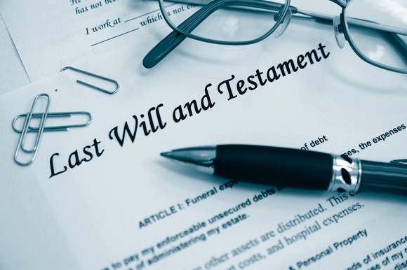Last will and testament document with pen and eyeglasses on top of it