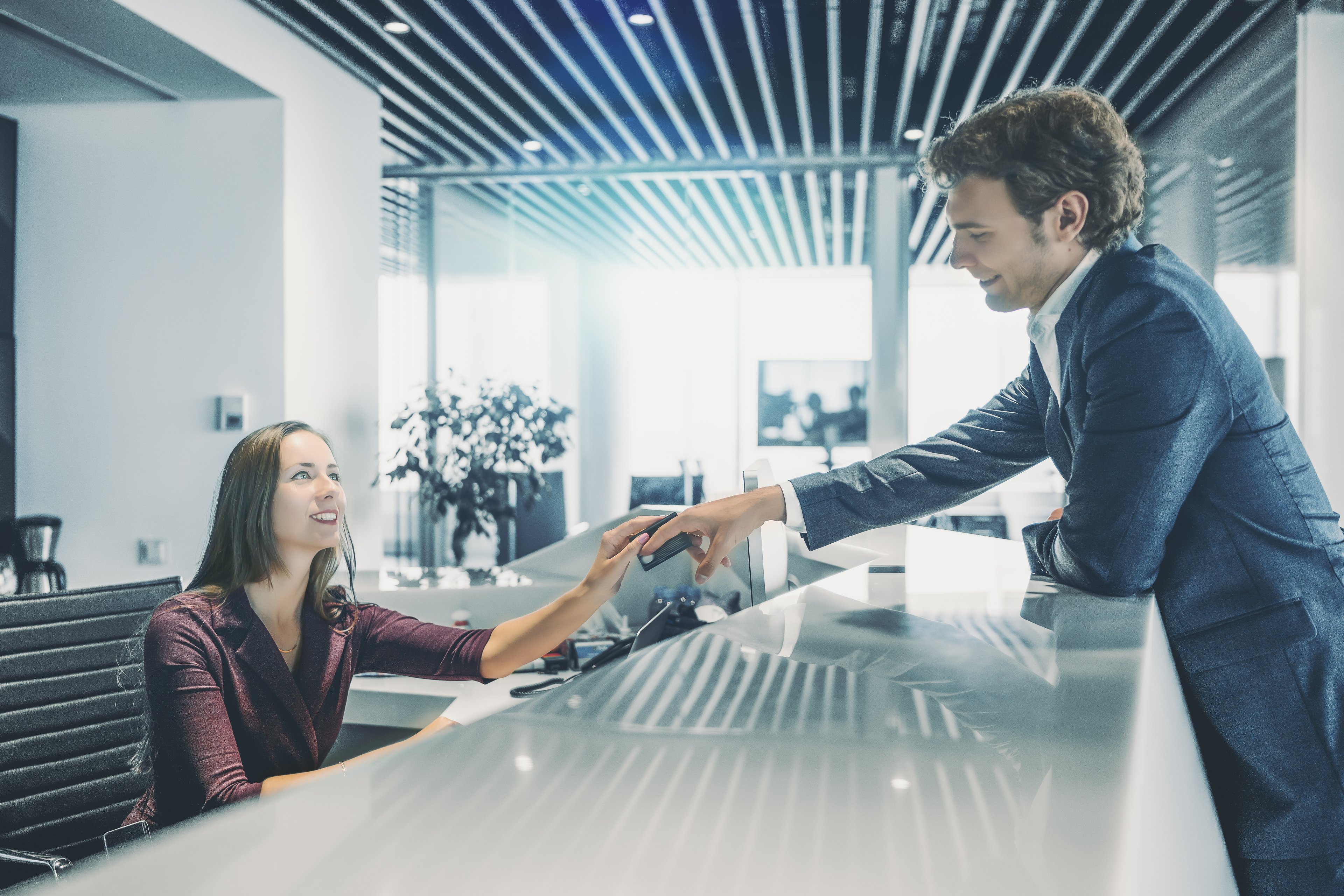 Man making a purchase at a hotel front desk