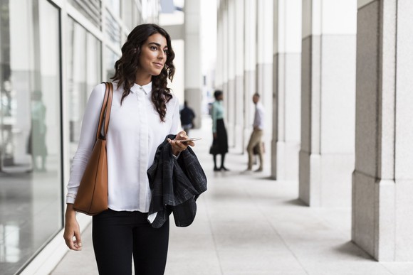 A woman waits for an Uber.