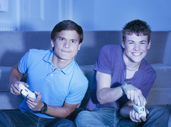 Two friends playing a console game.