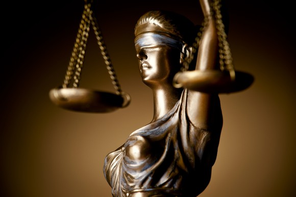 A statue of justice blindfolded and holding scales in her hand.