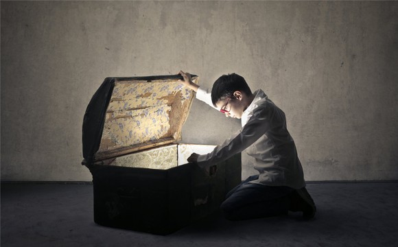 A boy opening a treasure chest.