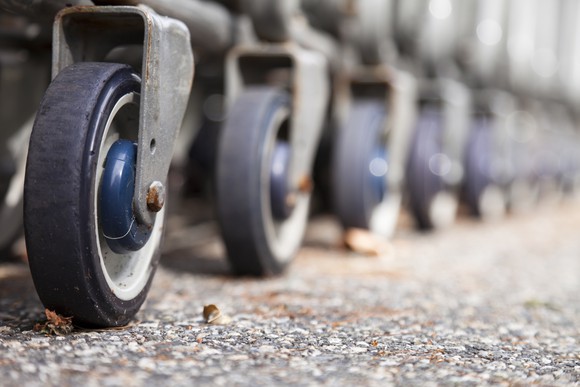A line of shopping cart wheels.