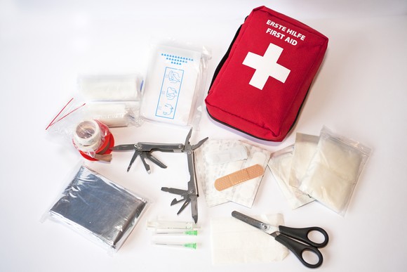 A first-aid kit is laid out.