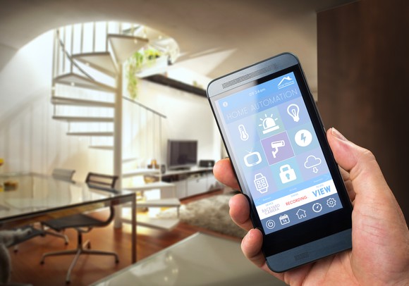 A person controlling home security and automation through a smartphone.