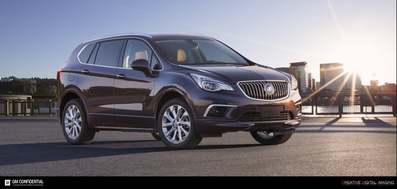 A 2017 Buick Envision with a skyline and sunset in the background. 