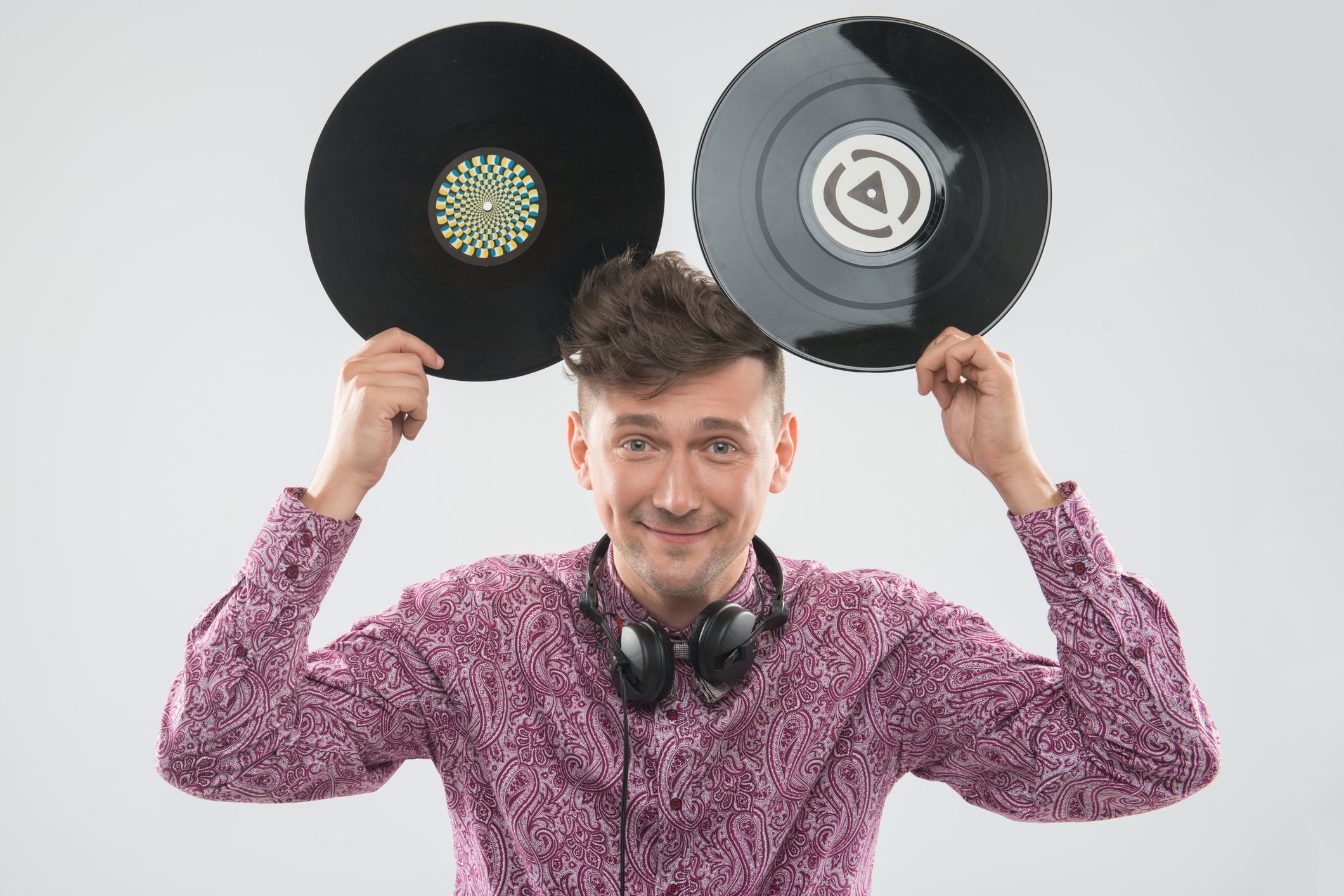 A man holding two records up like mouse ears