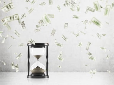 Hour glass with money raining around it