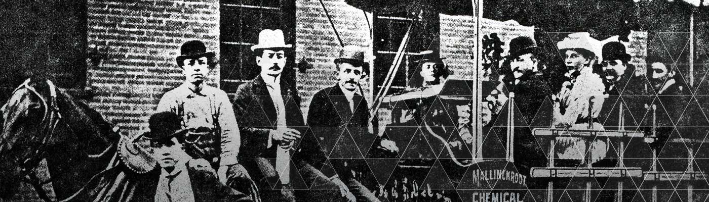 Historical picture of several people in a horse-drawn carriage with Mallinckrodt logo.