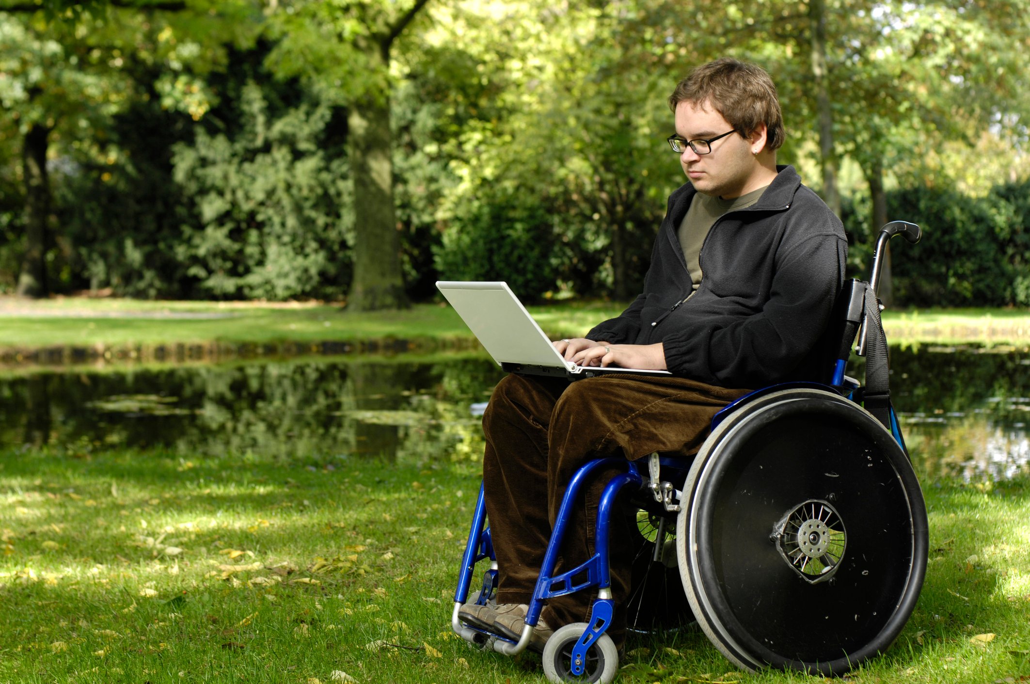 Young man with muscular dystrophy sitting in a wheelchair.