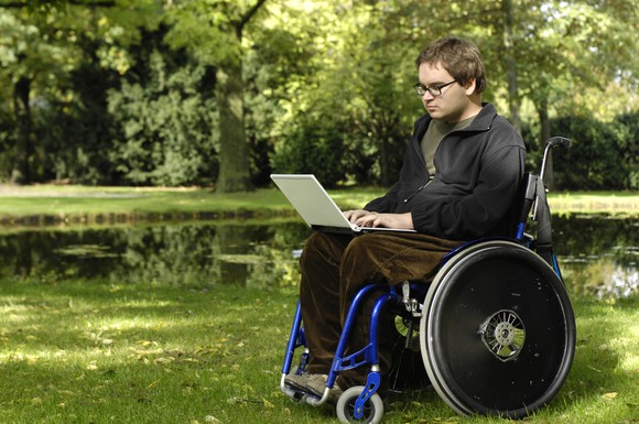 Young man with muscular dystrophy sitting in a wheelchair.