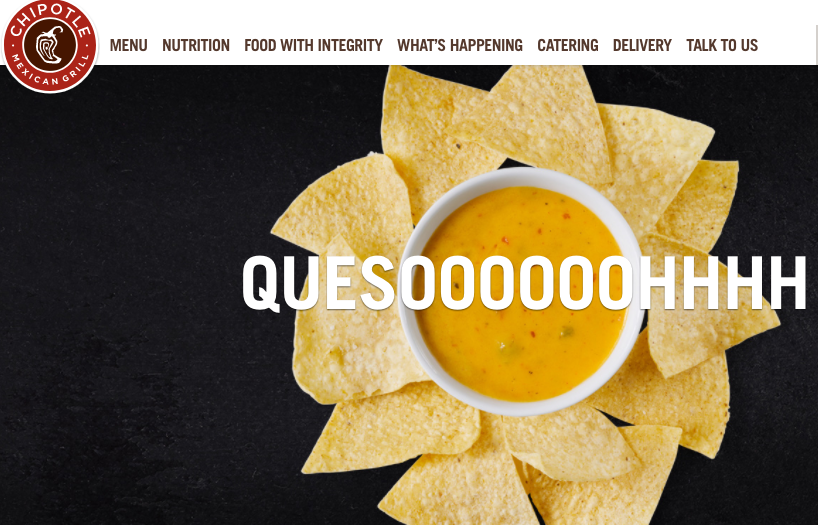 A side of chips surrounding a cup of Chipotle's queso.