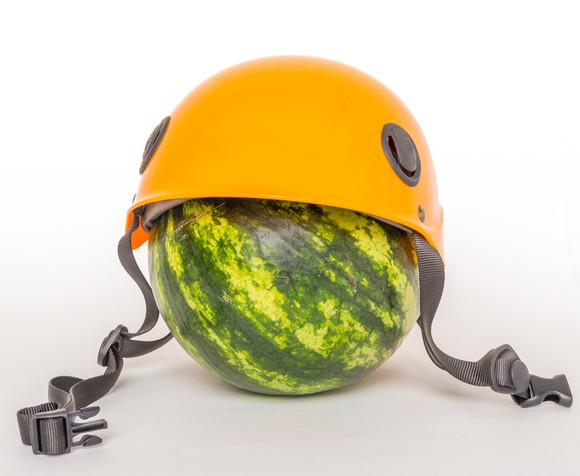 A watermelon wearing a helmet.