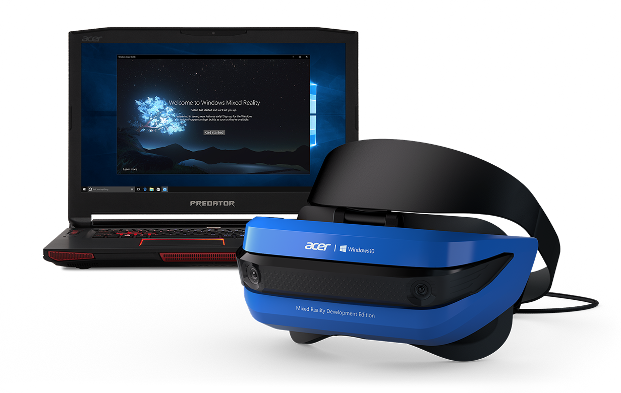 Virtual reality headset sitting next to computer.