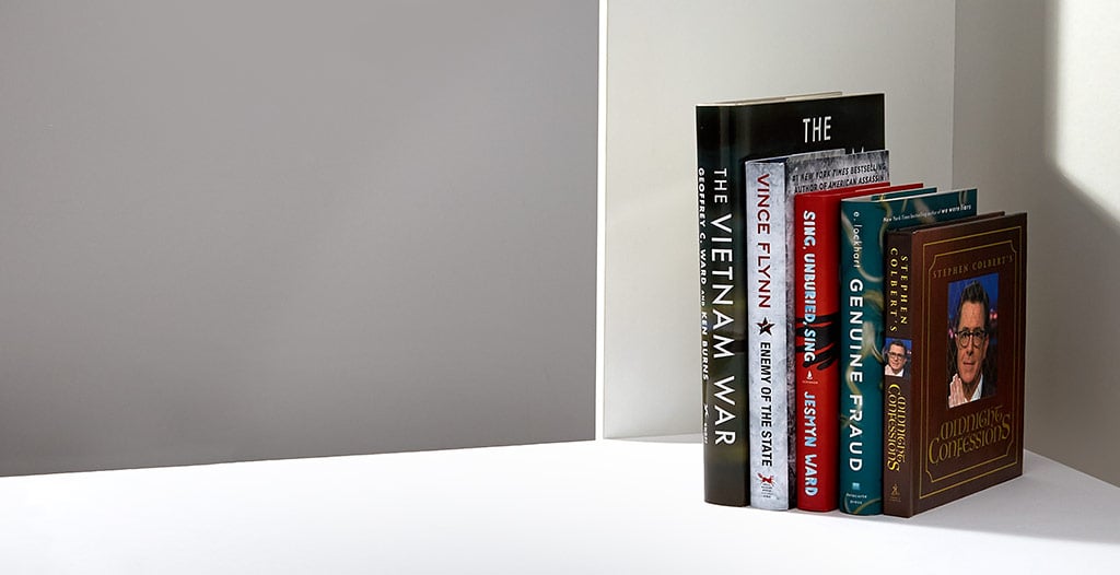 Several books in the corner of a bookshelf