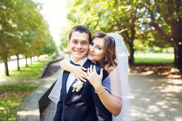 A bride wrapping her arms around her groom