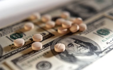 Drugs and pills on top of hundred dollar bills