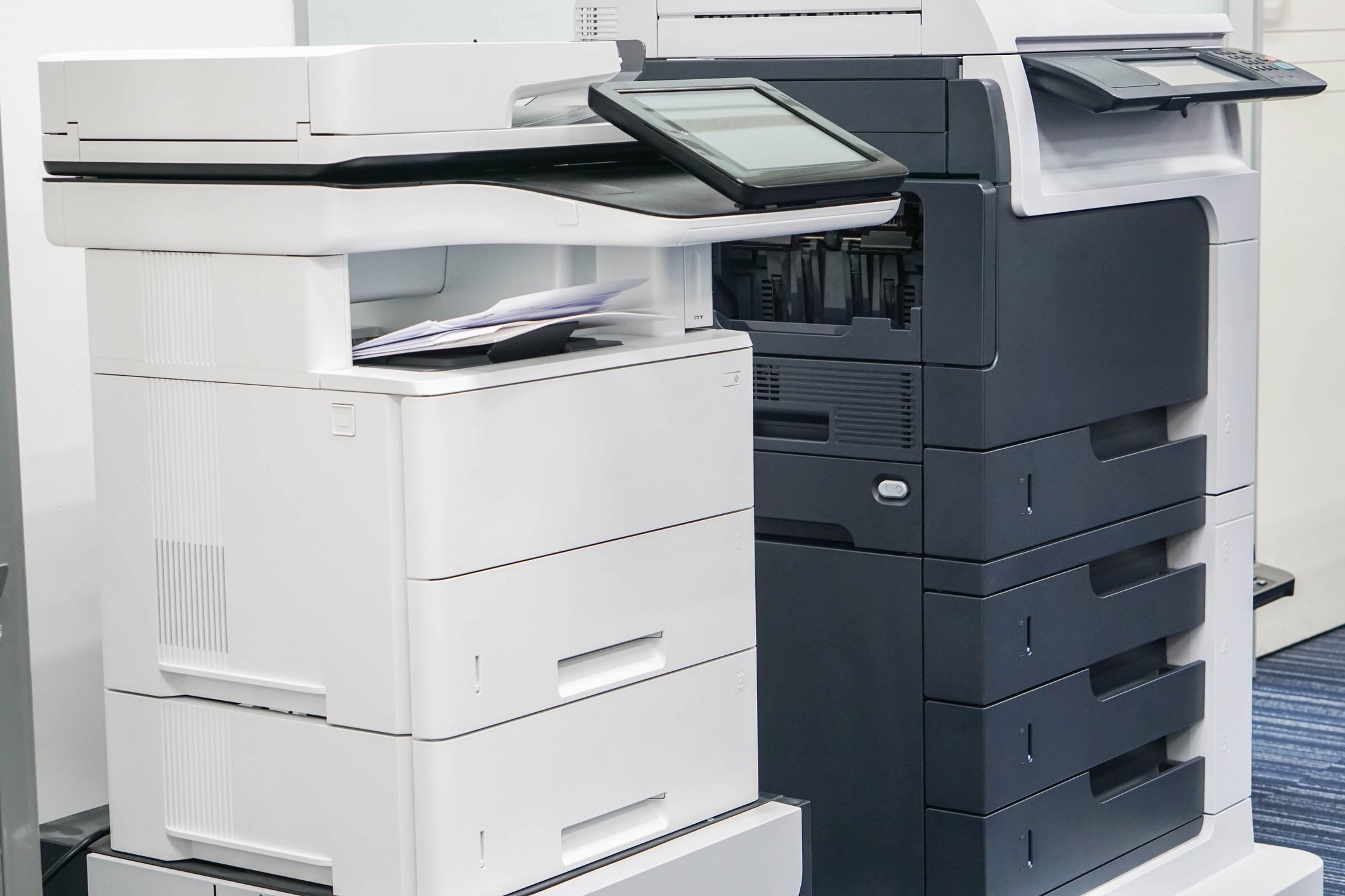 Two office-class printers, side by side.