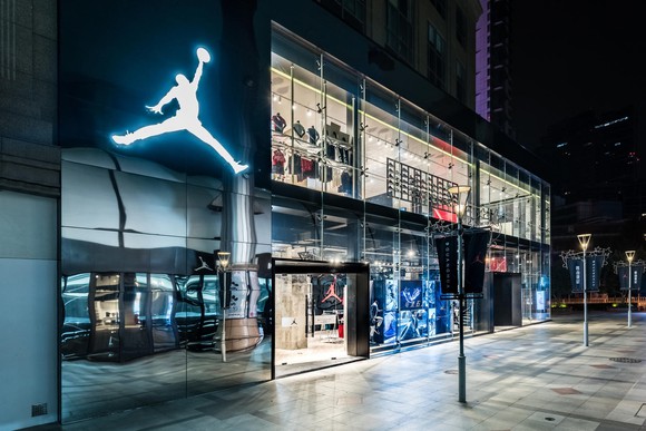 Michael Jordan's Jumpman Logo shines over a basketball court inside Nike's new Beijing store