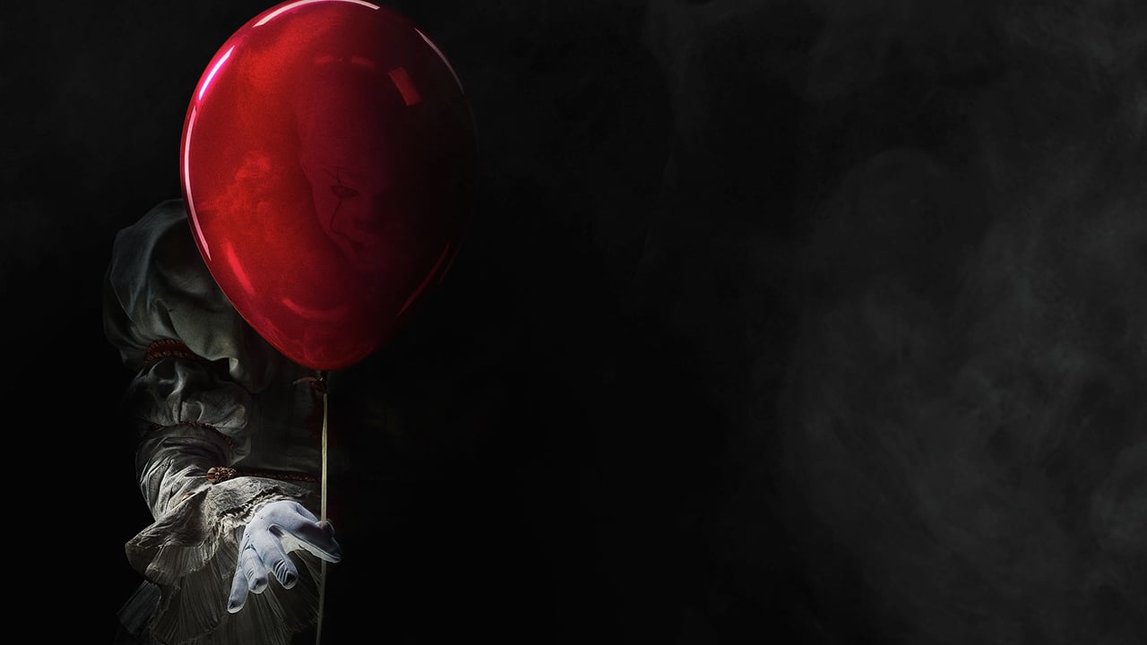 Pennywise, the villain clown from "It," holding a red balloon.