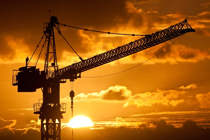 A silhouette of a crane at sunset.