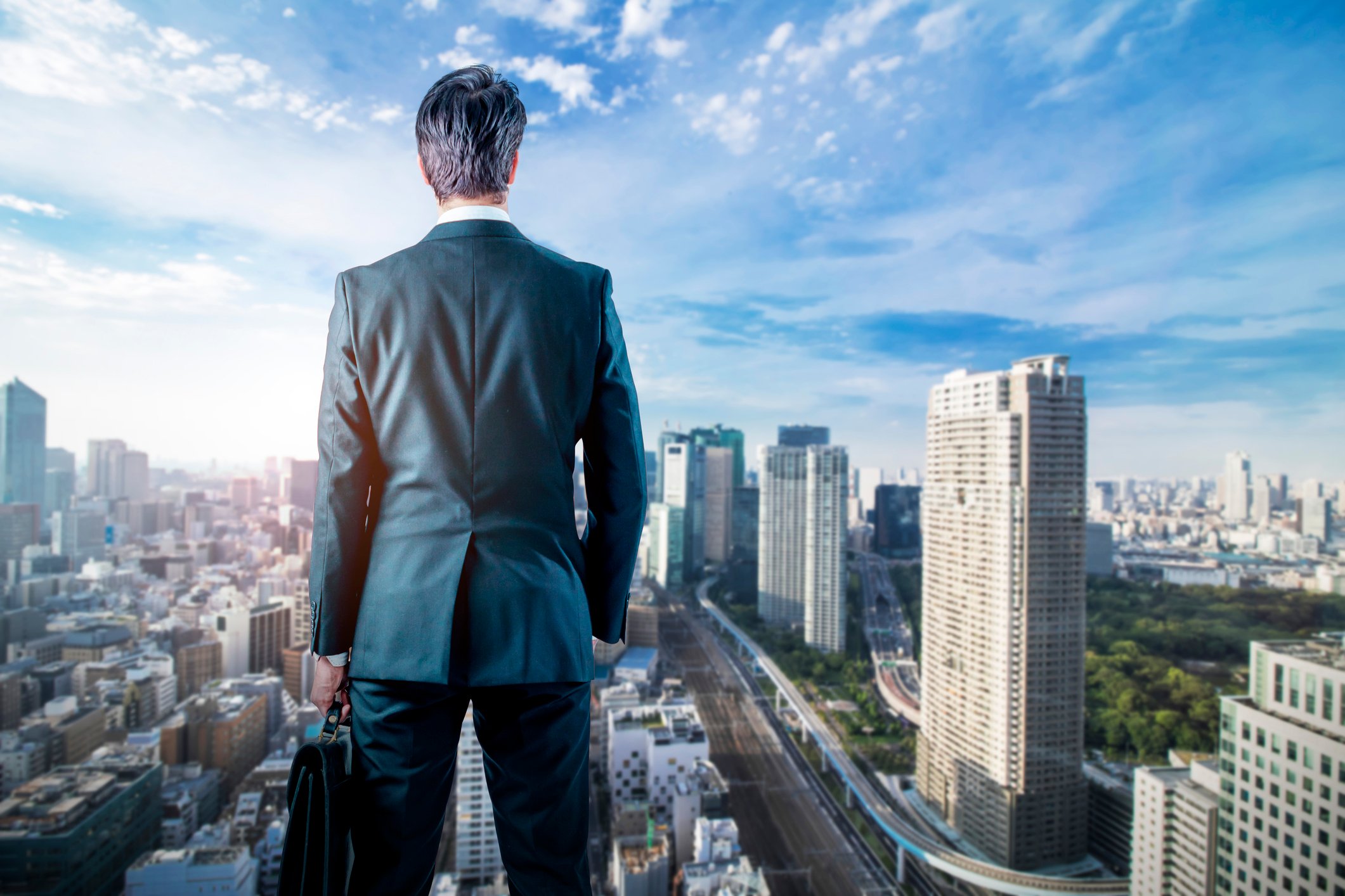 business person looking out over cityscape