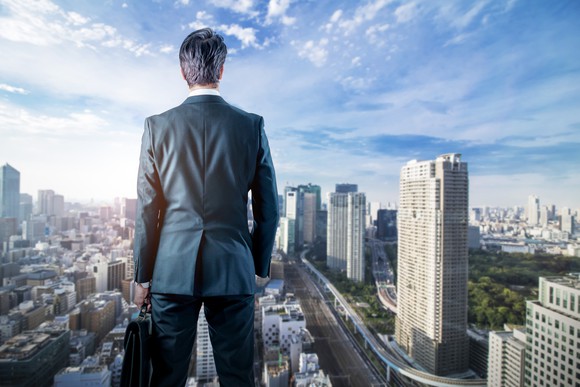 business person looking out over cityscape