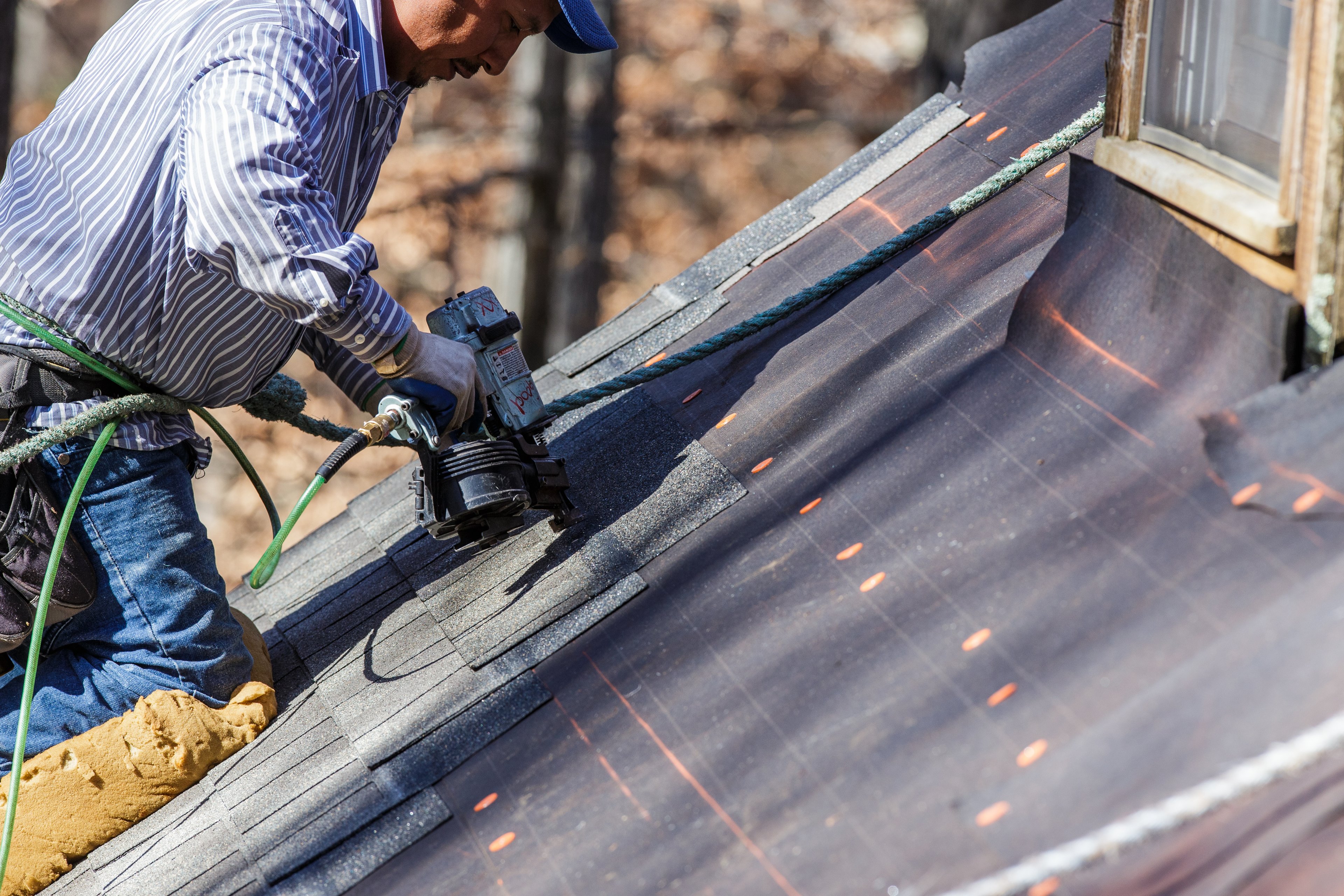a man fixing a roof