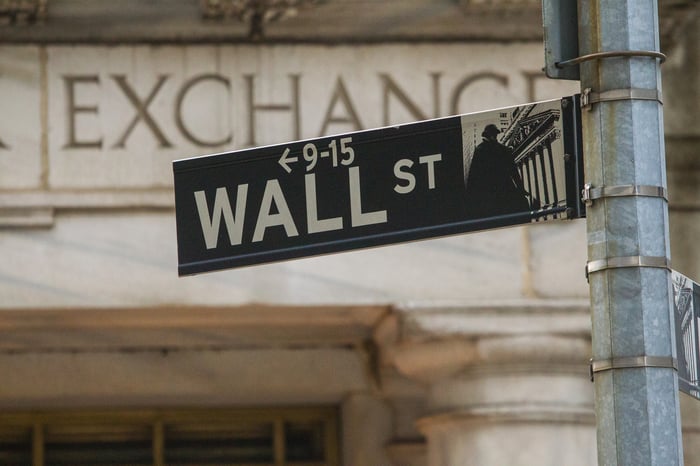 Wall Street sign with stone "Exchange" building in the background